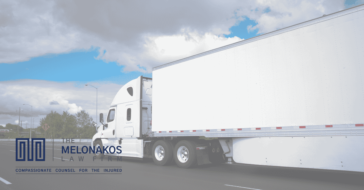 Passenger car traveling in the right-side blind spot of a semi-truck on a Greenville interstate